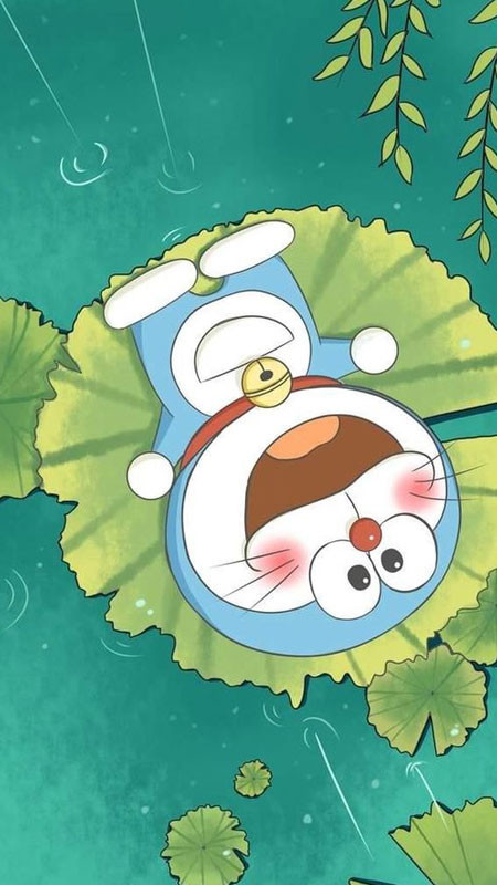 Hình Doremon chibi ngồi đáng yêu trên thảm cỏ xanh mướt