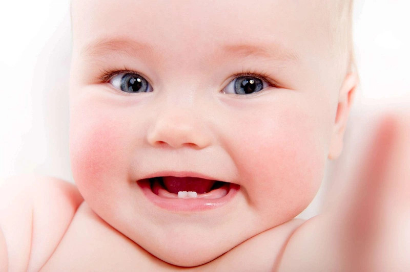 Bé đang được cha mẹ dỗ dành, giữ thái độ bình tĩnh khi bé mọc răng là rất quan trọng